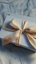 Briha gift box tied with a cream Briha ribbon bow