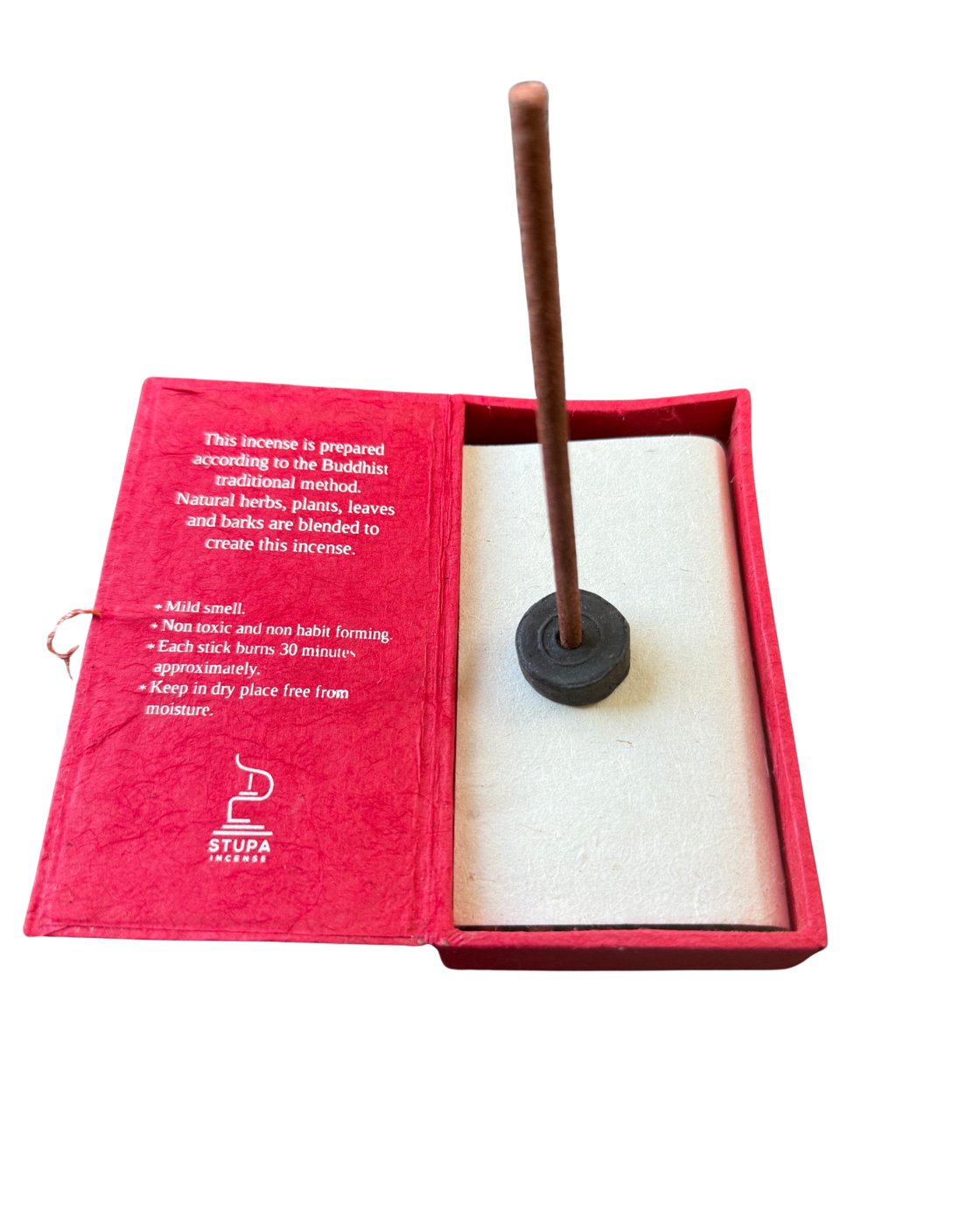 Austha Suganda incense stick standing in its holder inside the open red box
